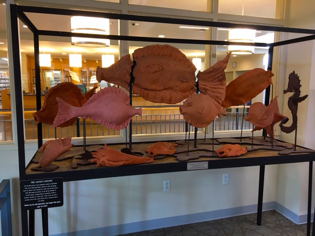 terra cotta fish in steel frame