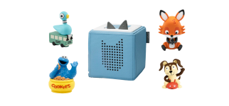  A light blue Toniebox audio player, cube-shaped with cat ears on top, is centered in the image. It is surrounded by four Tonies figures: The Pigeon (sitting on a green bus from Don't Let the Pigeon Drive the Bus!), Cookie Monster (sitting in a bowl of COOKIES), a fox, and a dog sitting on a red object.