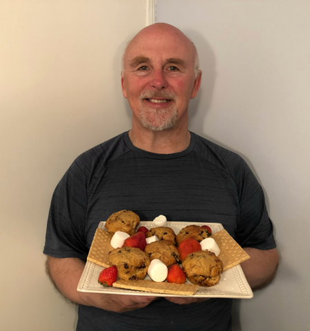 Chef Rob holding a plate of Smores Muffins.
