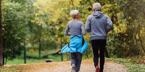 Photo of an older couple walking together.