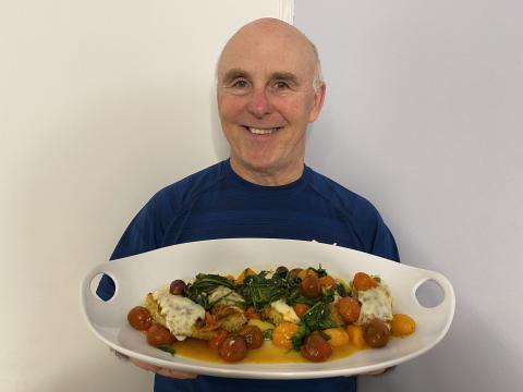 Photo of Chef Rob holding a platter of Panko Chicken Milanese.