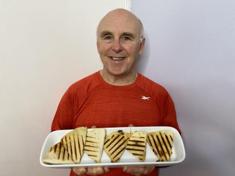 Photo of Chef Rob holding a plate of Chicken Quesadillas Fajita Style.