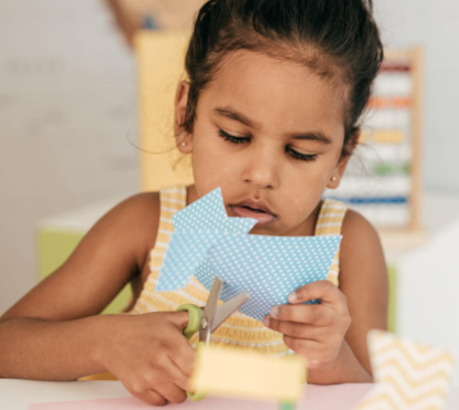 Child cutting with scissors