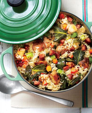 Photo of a green enamel pot with the lid askew. The pot contains a one-pot meal featuring greens and grains.
