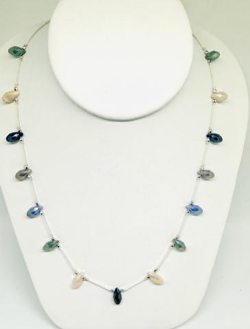 A color photo of a necklace made using the technique of silk knotting.