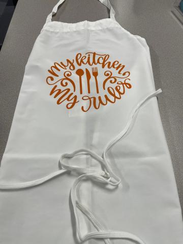 Photo of an apron customized with a design made on the Cricut.