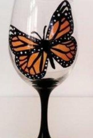 A photo of a wine glass painted with a butterfly.