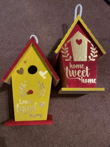 A photo of two birdhouses decorated using Cricut cutouts.