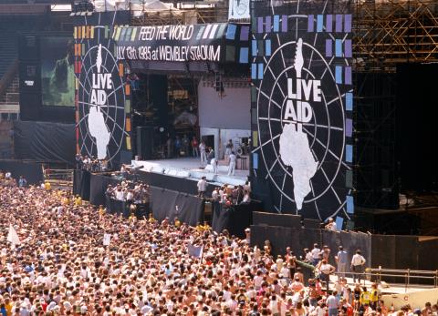 A photo of the Live Aid concert stage and crowd.