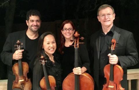 A color photo of the four members of the Poetica Ensemble holding their string instruments.