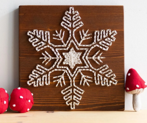 A color photo of a string art snowflake.