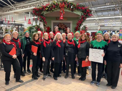 A color photo of the Island Hills Chorus dressed in holiday garb.