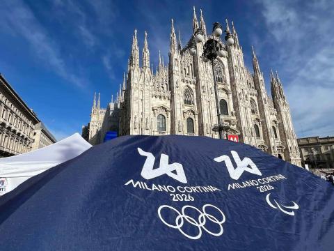 A photo of the Duomo in Milan with an Olympic banner in front.