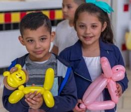 Children holding balloon animals