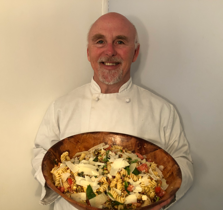 A photo of Chef Rob holding a bowl of pasta salad.