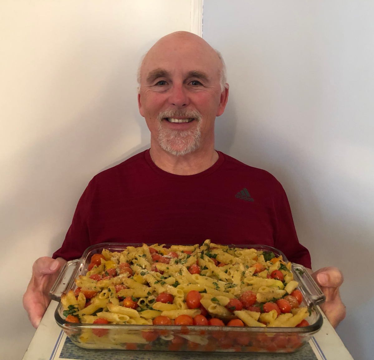 Photo of Chef Rob holding a dish of Pasta from Tuscany.