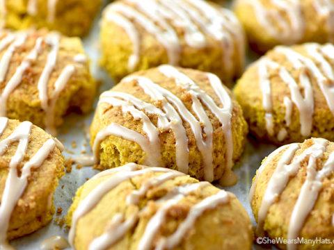 A photo of pumpkin scones with a white glaze.