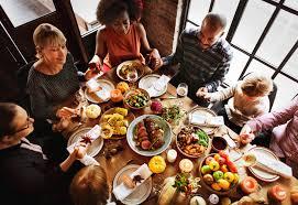 Photo of a family seated around a holiday table.