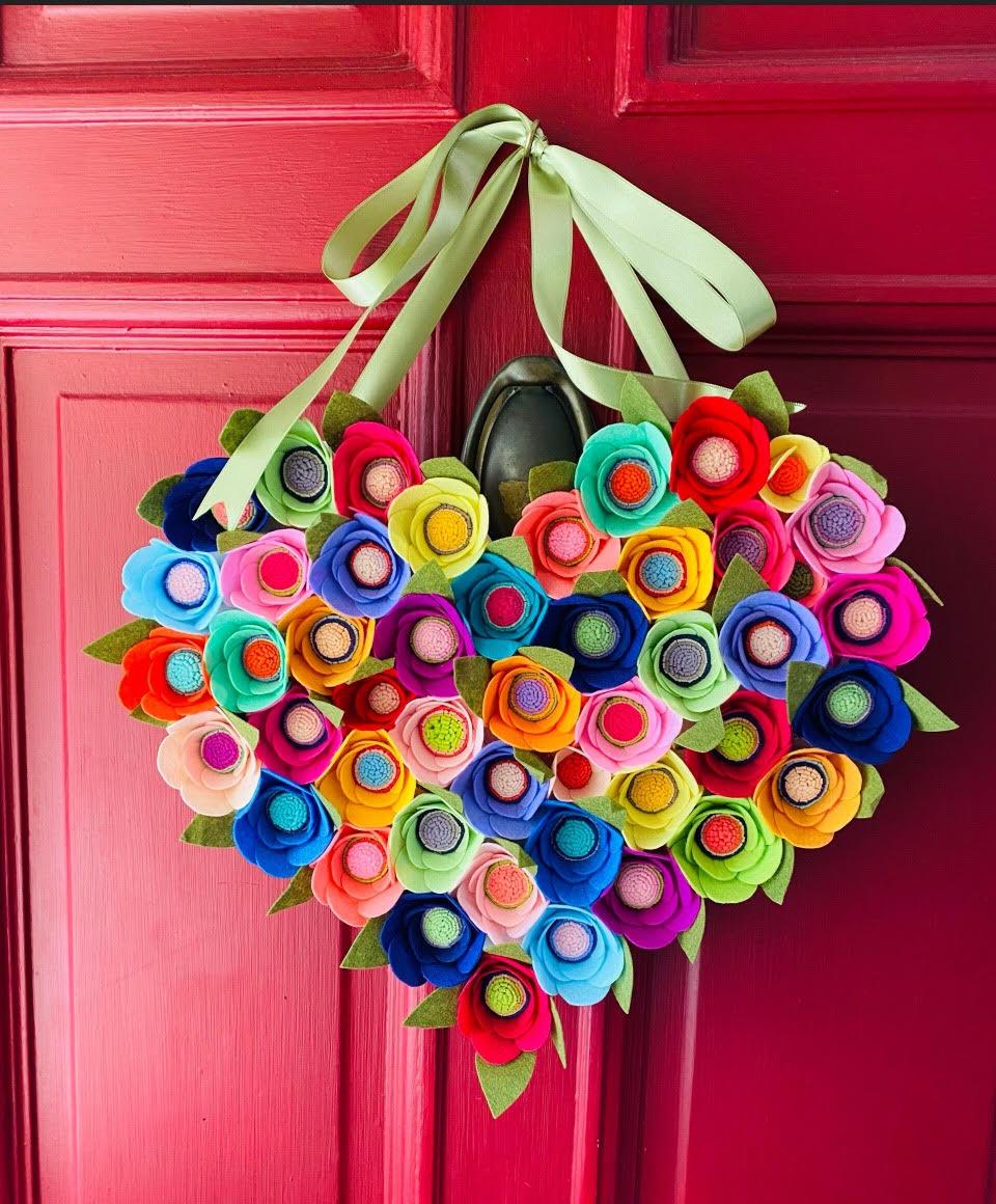 A color photo of a heart shaped felt door hanging.