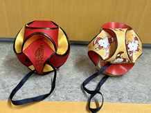 A photo of two red origami ornaments.