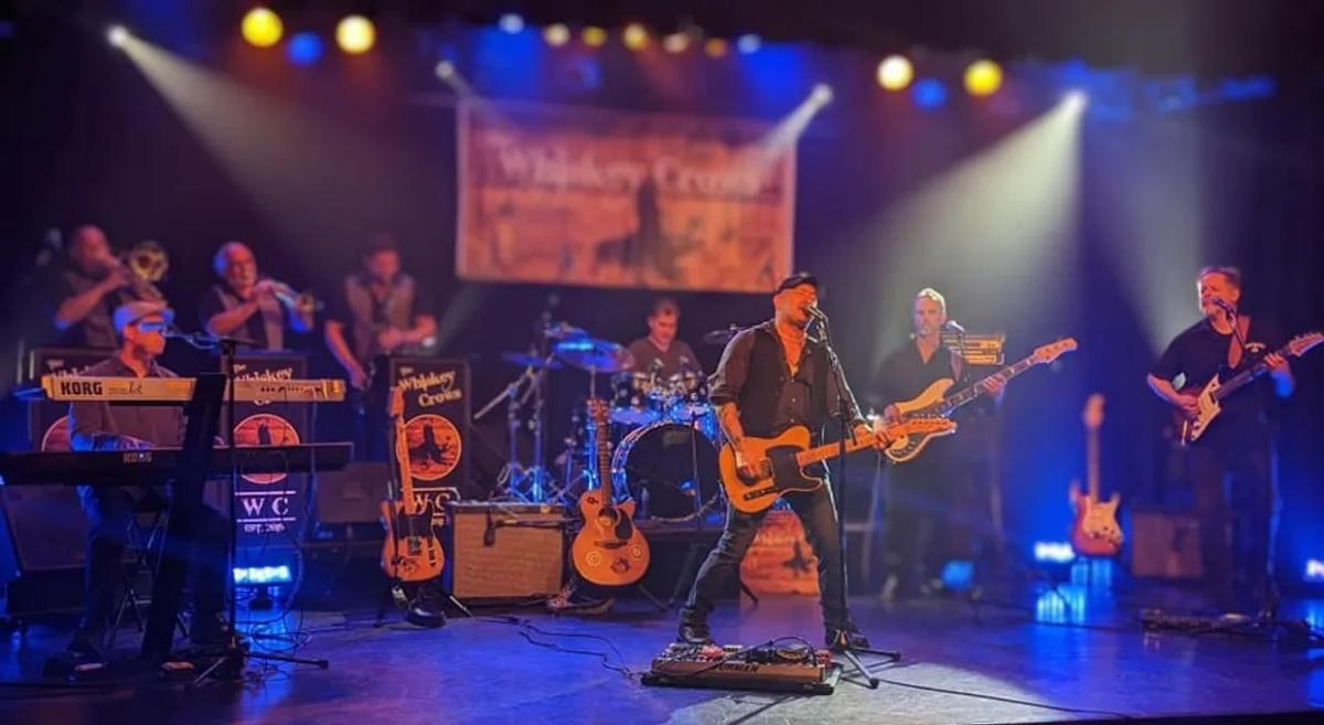 A photo of the band The Whiskey Crows on stage.
