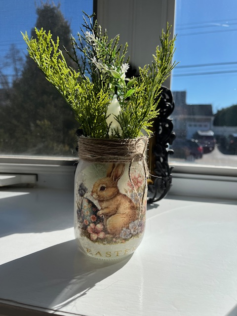 A color photo of a decoupage bunny jar.
