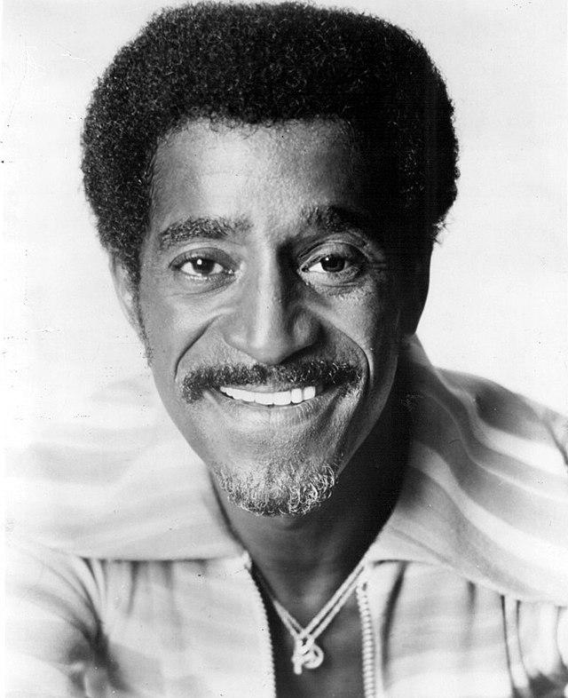 A black and white headshot of Sammy Davis Jr.