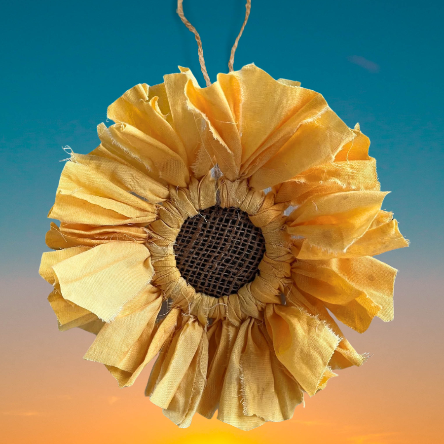 A photo of a sunflower made of fabric.