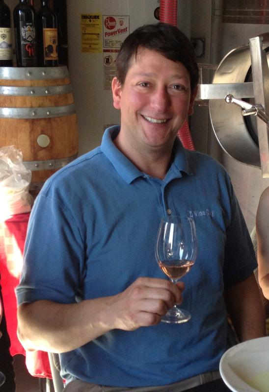 A photo of sommelier Pascal Zugmeyer holding a glass of wine.