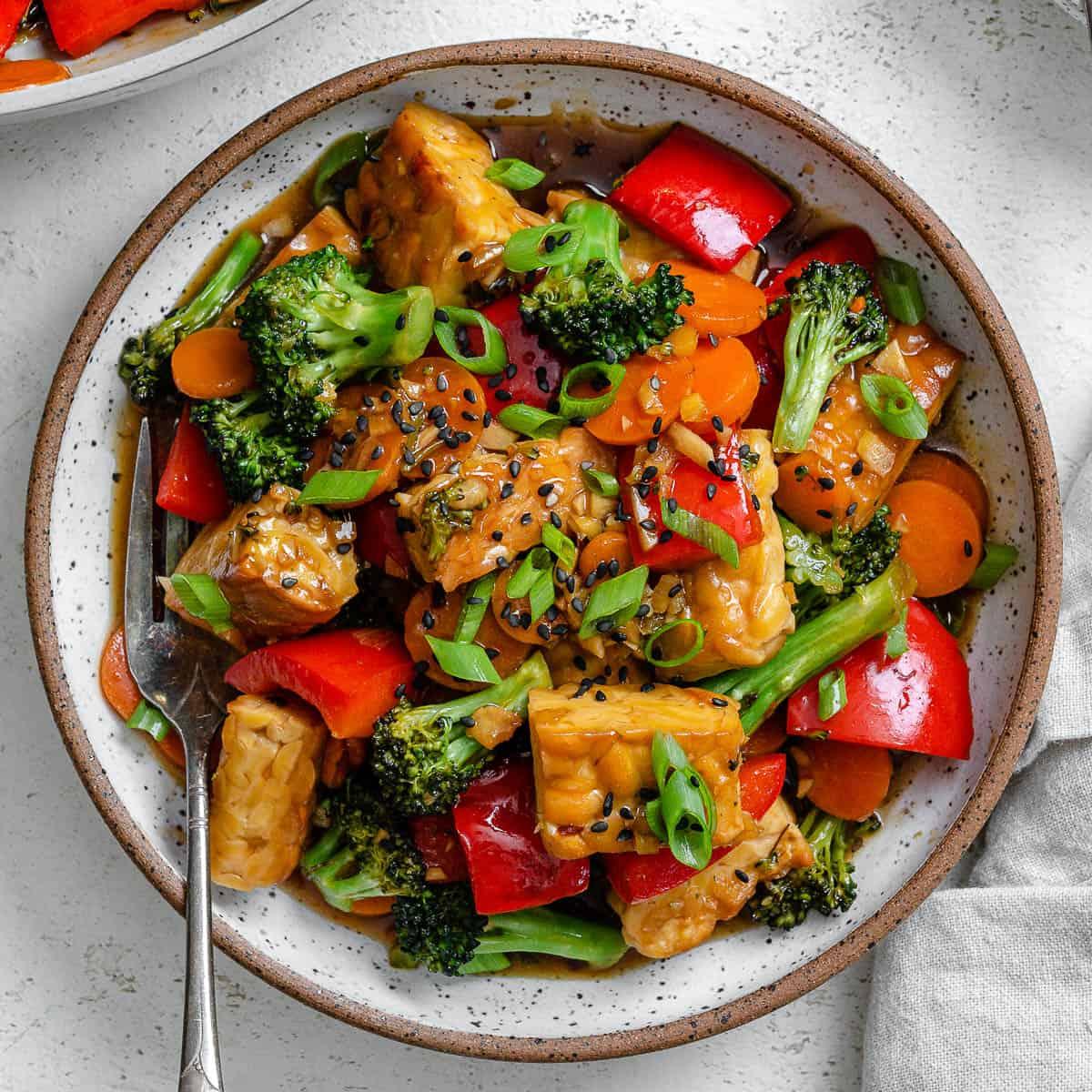 A photo of a bowl of tempeh stir fry.