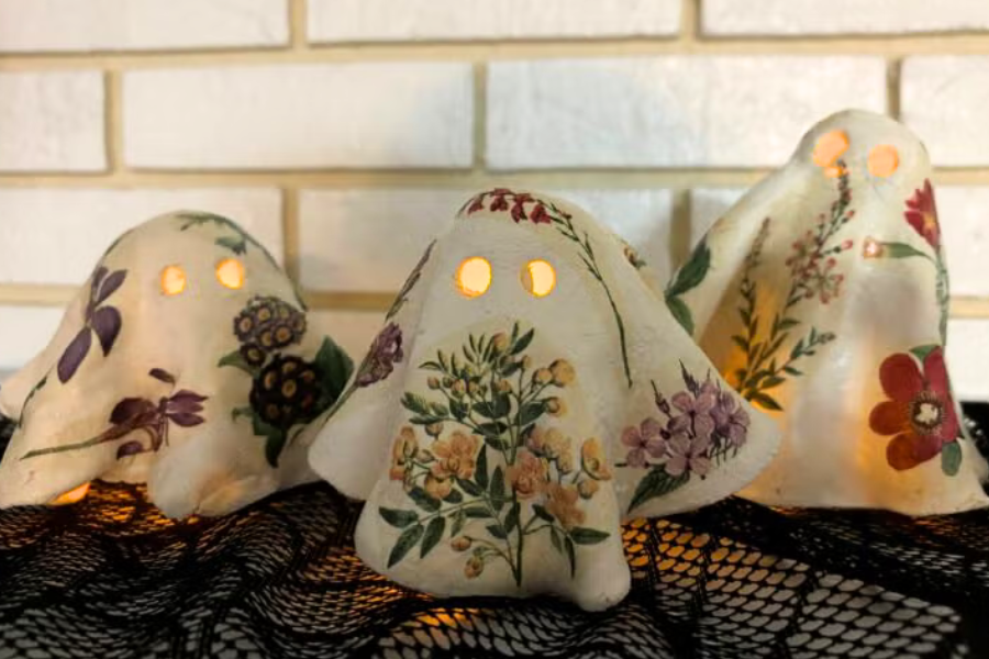 A color photo of three decoupage clay ghosts.