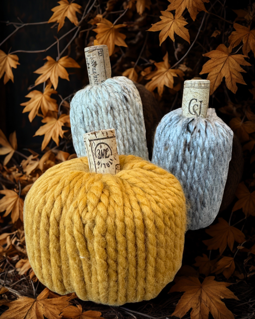 A color photo of three yarn wrapped pumpkins.