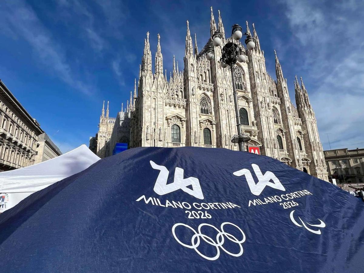 A photo of the Duomo in Milan with an Olympic banner in front.