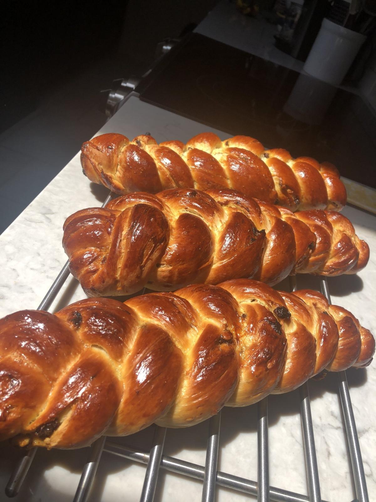 A photo of several loaves of challah bread.