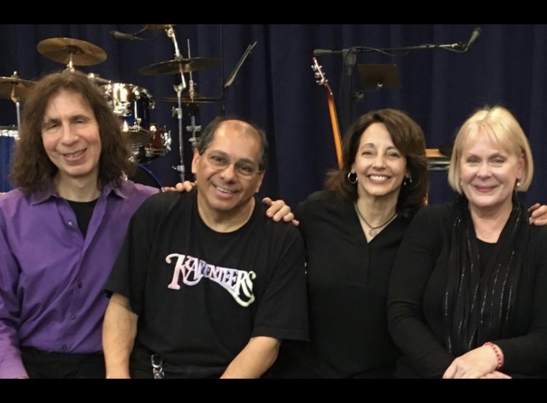 A color photo of the four members of The Karpenteers.